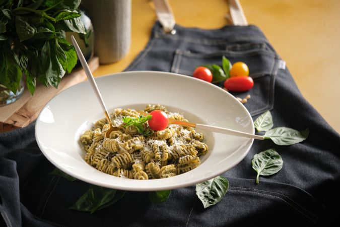 Plate with appetizing pasta radiatori with cheese on table