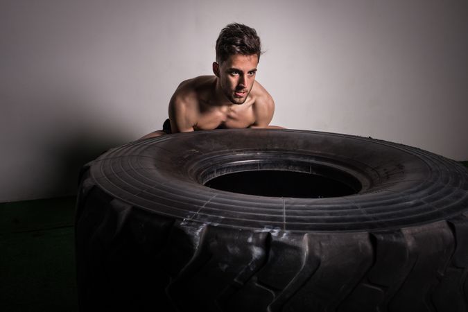 Man flipping big tires in gym