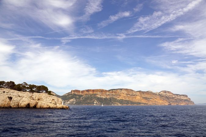 sailboat in sea and beautiful rocks