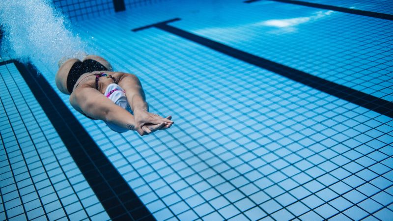 Female swimmer in action inside swimming pool