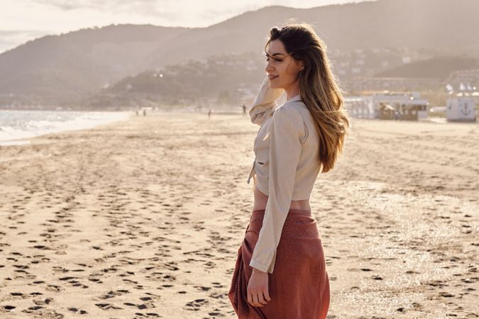 A fashion model at the beach before sunset