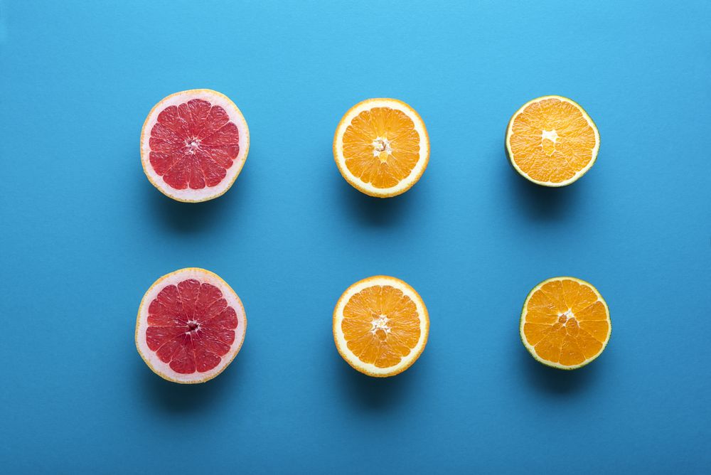 Fresh oranges and grapefruit cut in half