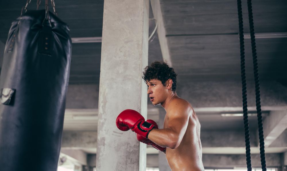 Boxer working out with punching bag