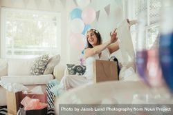 Pregnant woman with new gift at baby shower 48B7jX