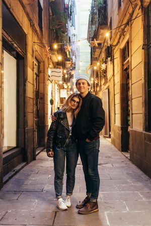 Man and woman in cosy lit European alley