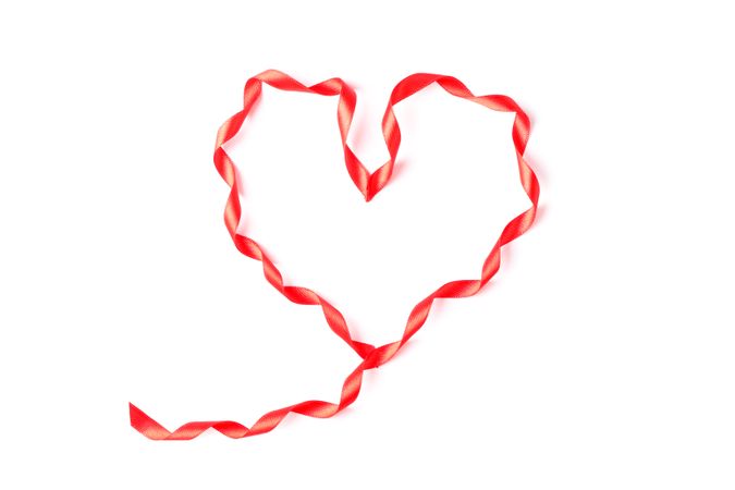 Red ribbon heart isolated on blank background