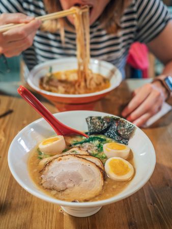 Female eating Japanese dish
