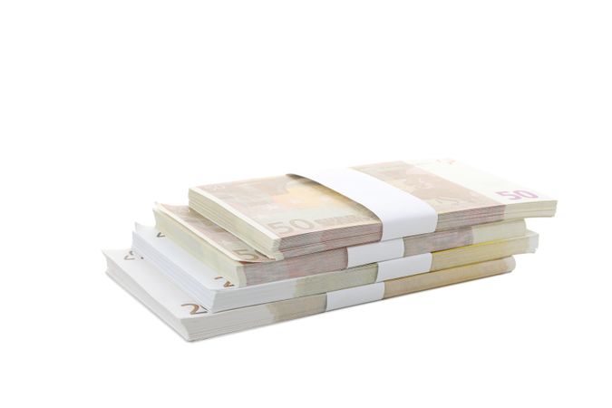 Stacks of American cash money, isolated on light background