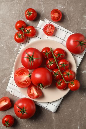 Composition with tomatoes on gray background, top view