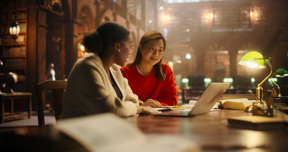 Engaged Multiethnic Students Studying Together in a Classic Library
