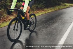 Cyclist training outdoors on a rainy day 47mZMP