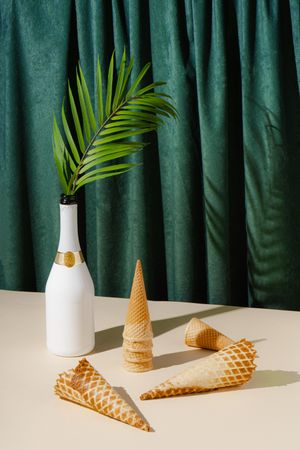 Waffle cones and champagne in front of green curtain background