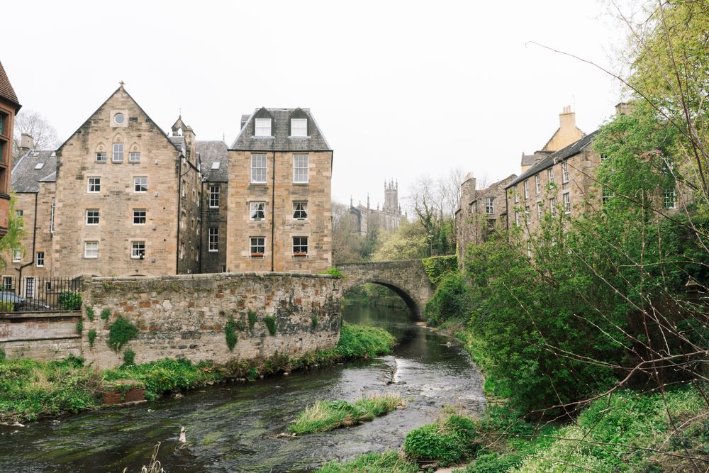 Aged stone buildings with green bushes around