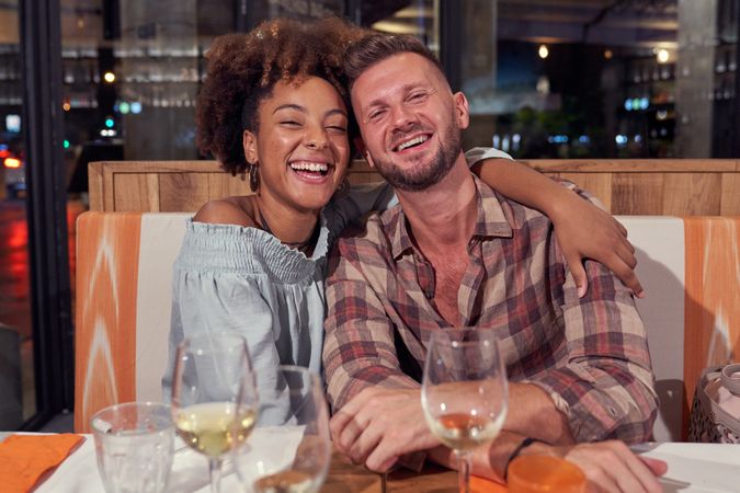 Happy multiethnic couple in restaurant
