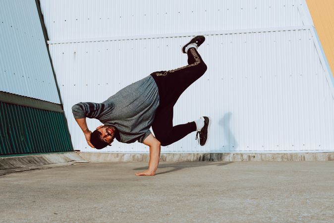Man performing handstand near wall