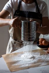 Faceless cook preparing flour and eggs for cooking