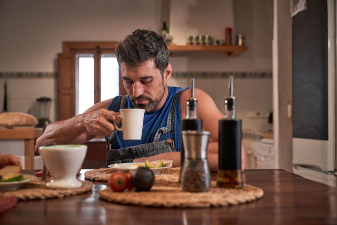 Mature man drinking coffee in kitchen