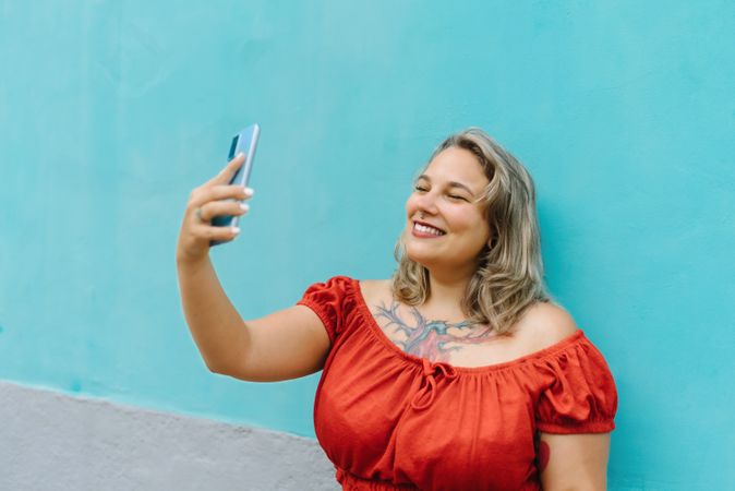 Young woman taking selfie on smartphone