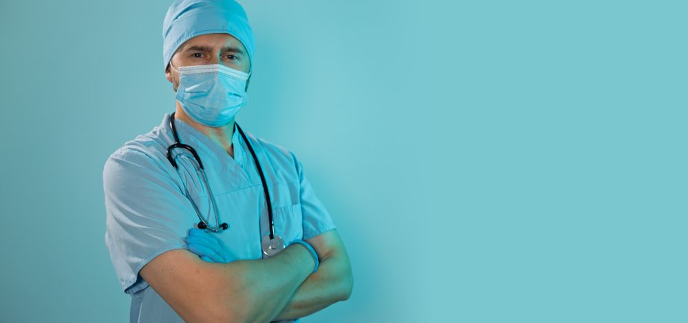 Professional doctor standing with folded arms