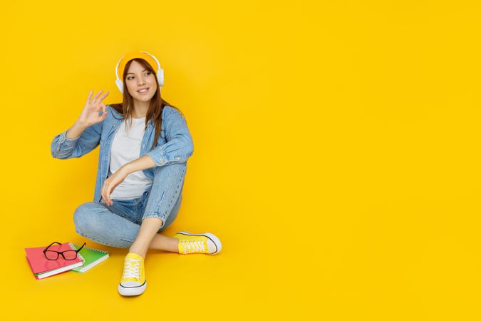 Concept of people, young woman on yellow background