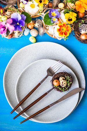 Easter holiday card concept with top view of plate on bright blue table