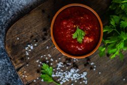 Top view of traditional Georgian sauce - satsebeli with parsley garnish