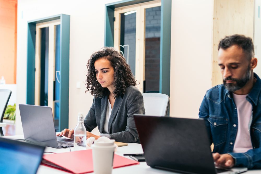 people working with laptop in a coworking