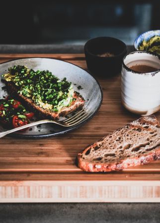 Avocado toast on sourdough bread, with cherry tomatoes  coffee, toast, bowl, square crop