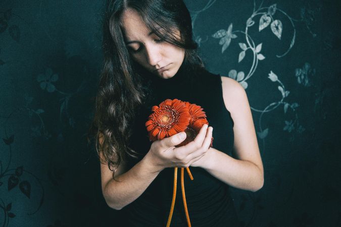 Portrait of woman with holding gerbera flower