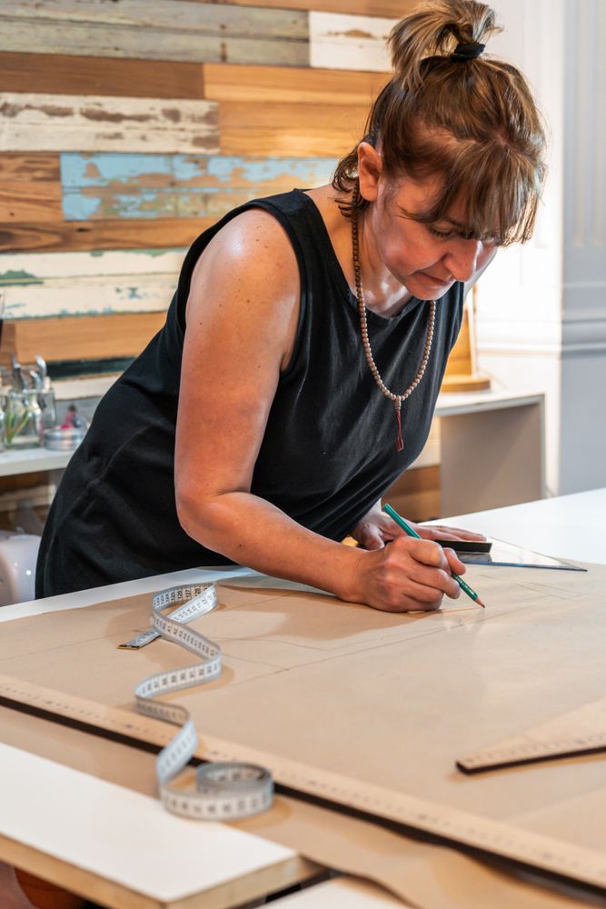 Fashion designer drawing fashion patterns. Vertical shot