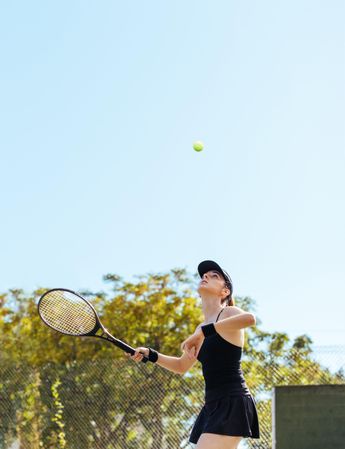 Female tennis player about to hit the ball