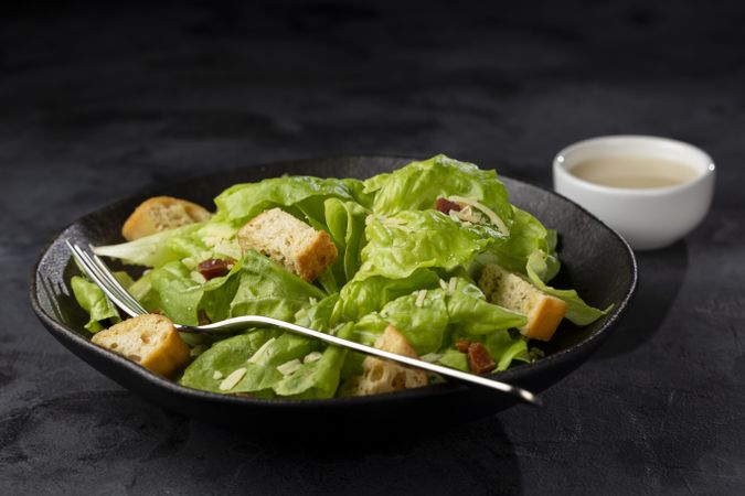 Caesar salad with croutons and bacon.