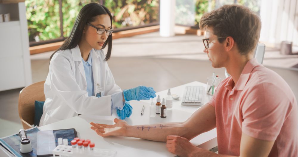 Young Asian Allergist is Conducting a Prick Scratch Test to Diagnose Any Allergic Reaction on a Young Male's Forearm During a Health Check Visit to a Medical Clinic.
