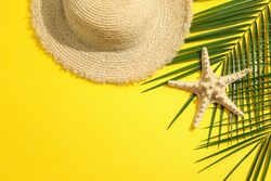 Summer vacation composition on yellow background. Space for text, top view