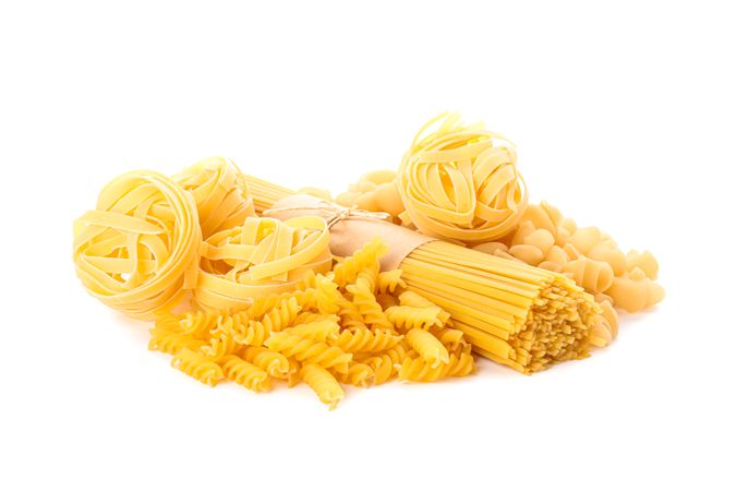 Pasta isolated on bright background. Uncooked whole wheat pasta