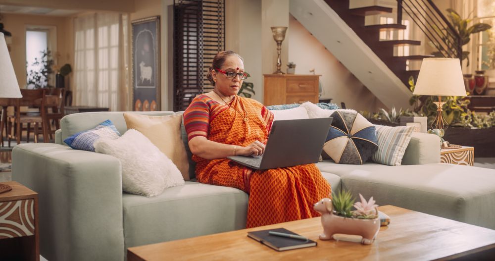 Mature Woman Using Laptop at Home: Using Internet, Connecting with Loved Ones On Social Media, Exploring New Interests.