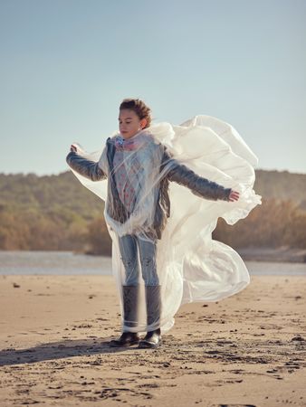 Girl restricted by plastic sheet on beach