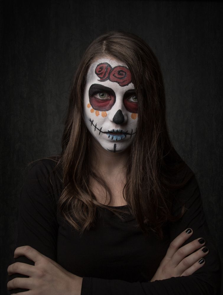 Young woman with creepy face paint