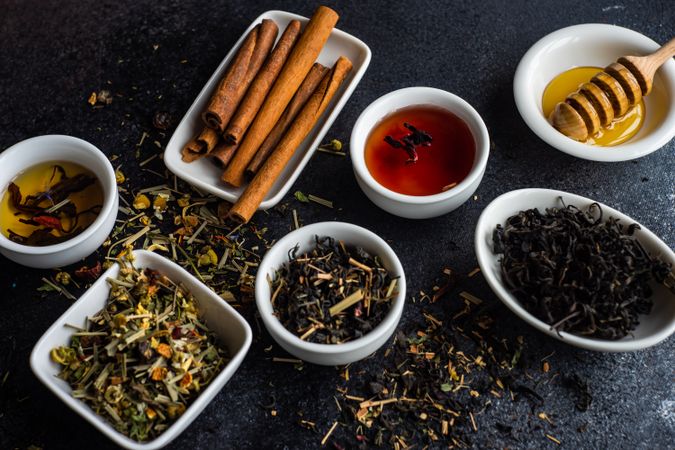 Loose leaf teas in bowls with cinnamon and honey