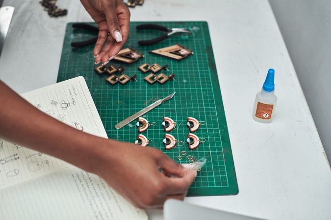 Woman cutting up pieces for earrings