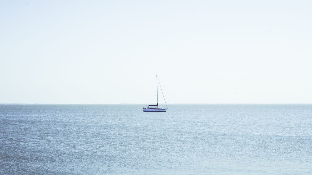 Boat between waves on water surface