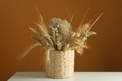 Beautiful dried floral arrangement in wicker basket