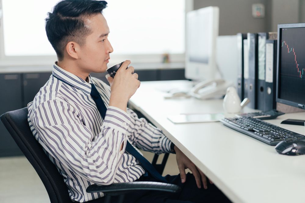 Investor broker analysing indexes data, financial chart trading online