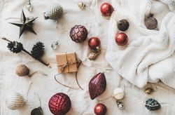 Flat-lay of holiday decoration, with knitted sweater, top view
