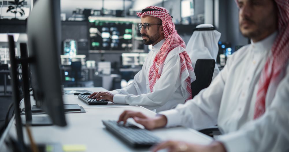 Two Young Middle Eastern Colleagues Working in a Cyber Security Software Development Department.