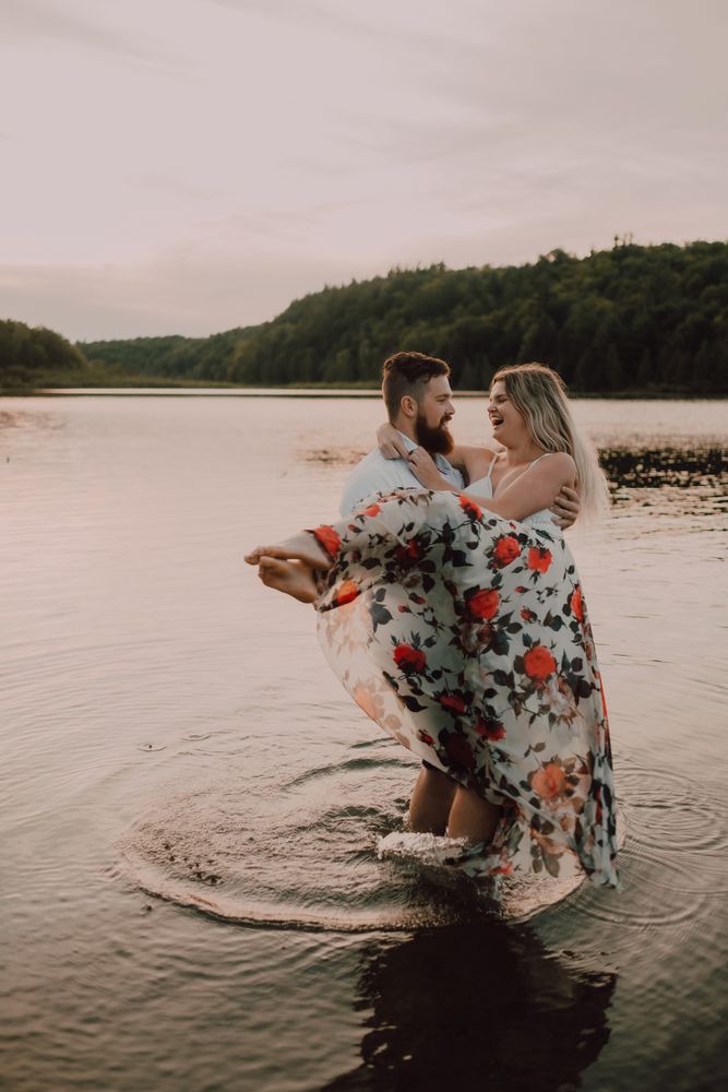 Loving couple standing ankle deep in water on beach