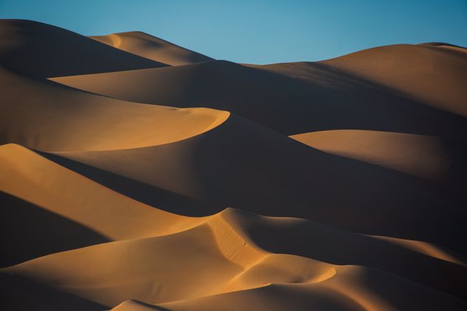 Sand mountains under blue sky