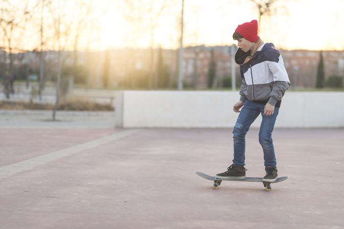 Young man riding on skateboard in park