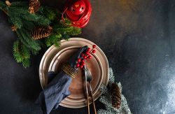 Top view of Christmas table setting with lantern and fern
