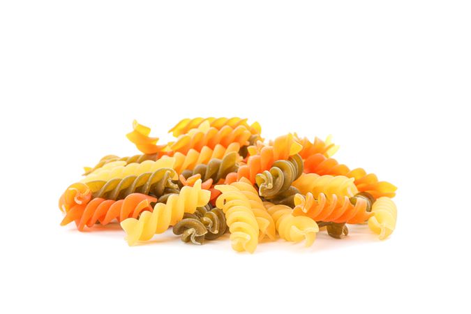 Pasta isolated on bright background, closeup. Dry uncooked whole pasta